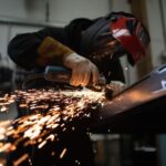 Grinding - person in black jacket holding brown wooden rolling pin