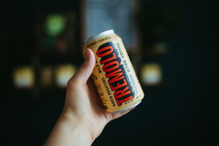 Nitro Coffee - a hand holding a can of food
