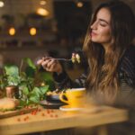 Functional Coffee - woman holding fork in front table