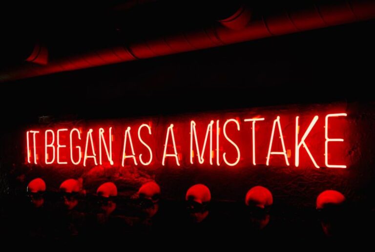 Mistakes - a neon sign that says itbegan as a mistake