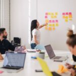Training - woman placing sticky notes on wall