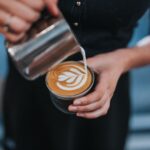Latte Art - person holding coffee with latte cup