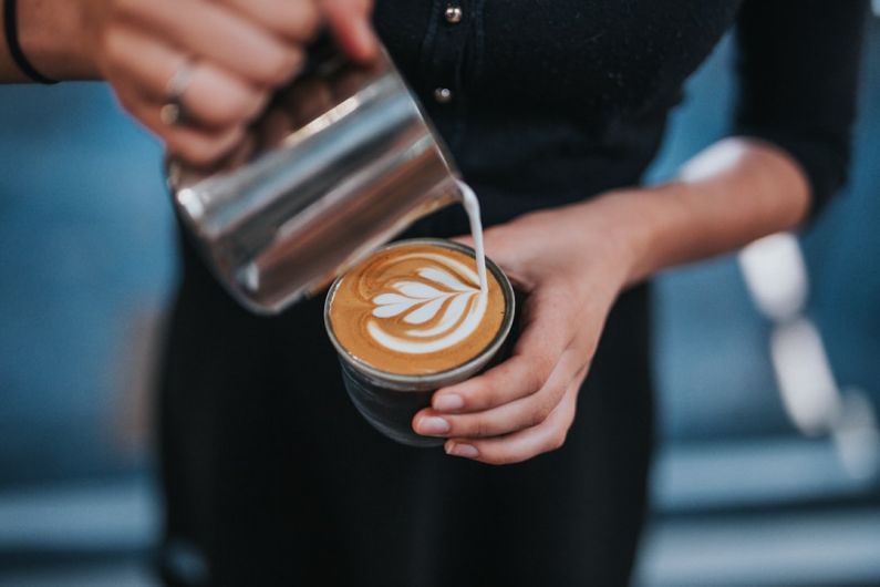 Latte Art - person holding coffee with latte cup