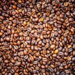 Medium Roast - a pile of coffee beans sitting on top of a table