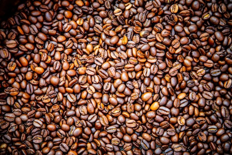 Medium Roast - a pile of coffee beans sitting on top of a table