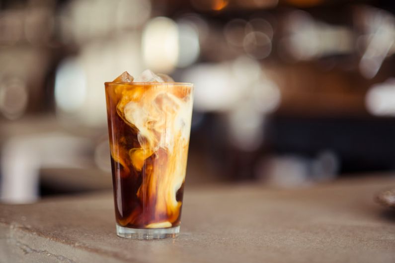 Unwashed Coffee - glass cup filled with ice latte on tabletop