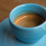 Bitter Espresso - half-filled ceramic cup on saucer