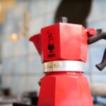 Ristretto - red coffee maker on brown wooden table