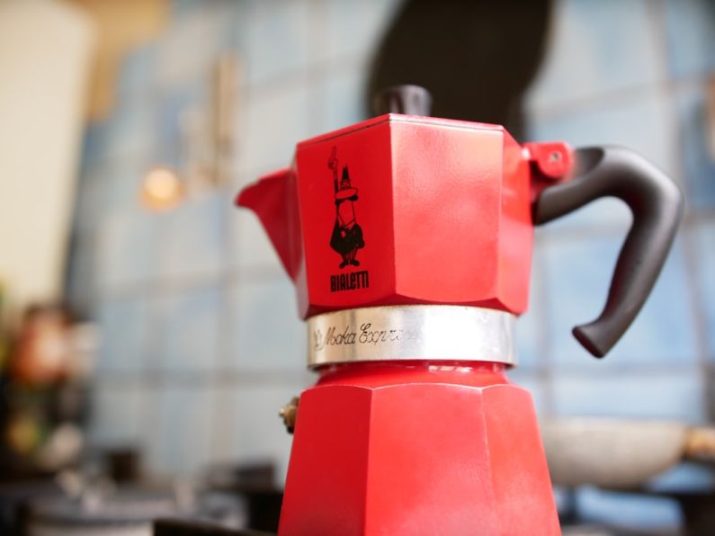 Ristretto - red coffee maker on brown wooden table
