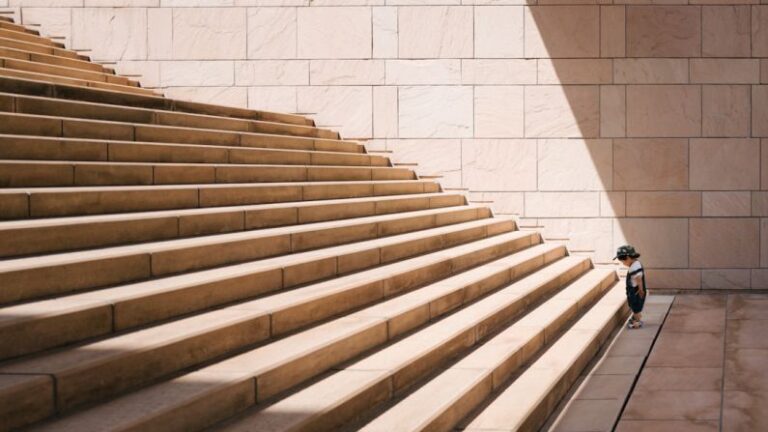 Challenges - toddler's standing in front of beige concrete stair