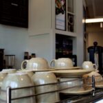 Best Coffeehouse - white ceramic mugs on stainless steel rack
