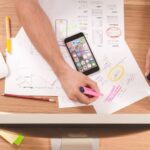 Design Trends - person writing on white paper