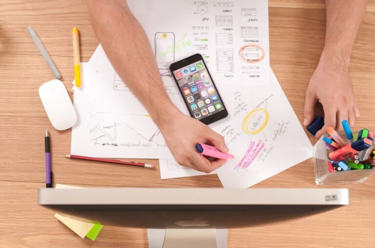 Design Trends - person writing on white paper
