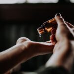 Aroma - person holding amber glass bottle