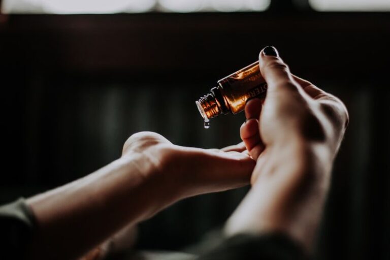 Aroma - person holding amber glass bottle