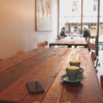 Café-Quality - two gray ceramic mugs on brown wooden dining table
